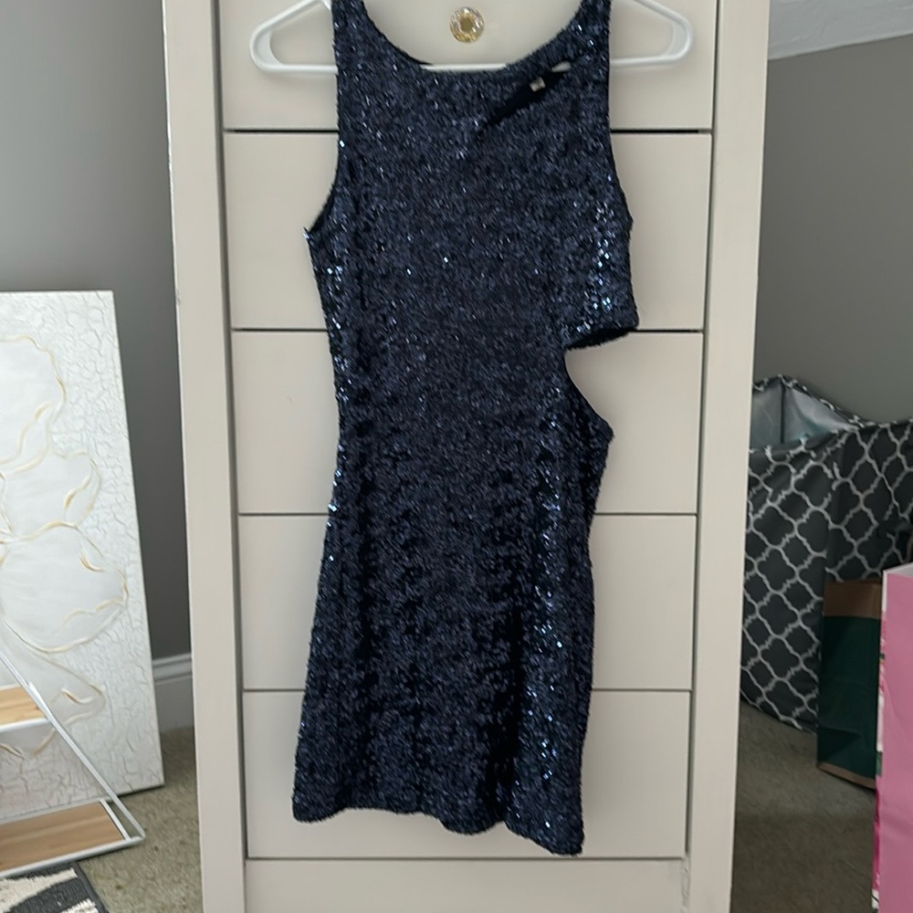 Navy blue sequins bodycon dress with cutouts.